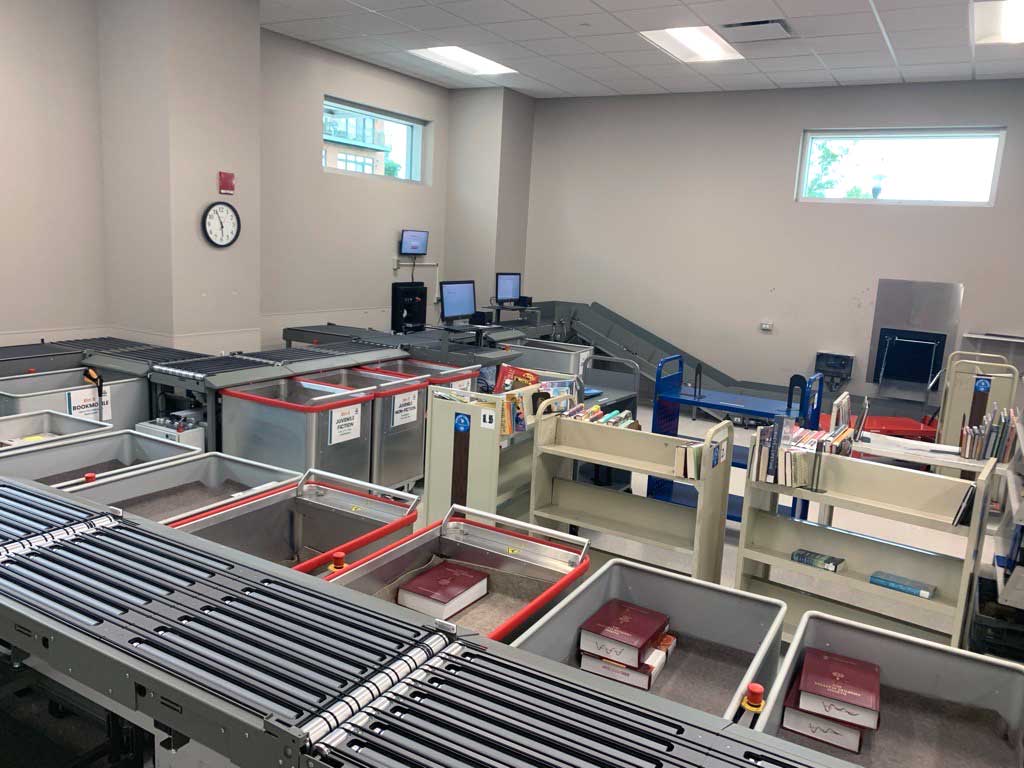 flexAMH automated materials handling system with bins sorting returned books at Aurora Public Library