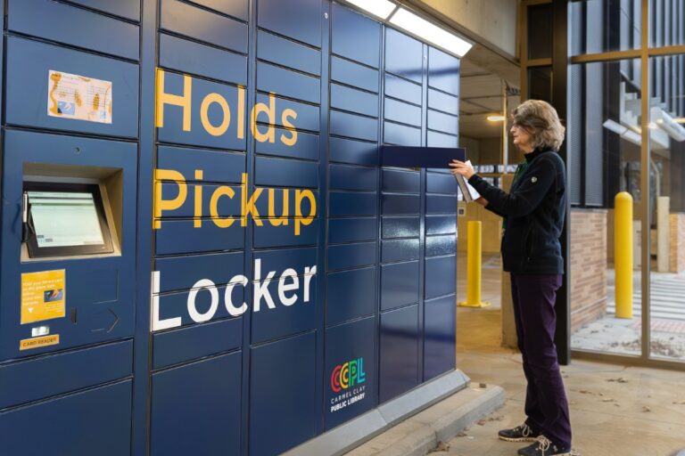 Library patron using the Bibliotheca remoteLocker at Carmel Clay Public Library to pick up reserved items.