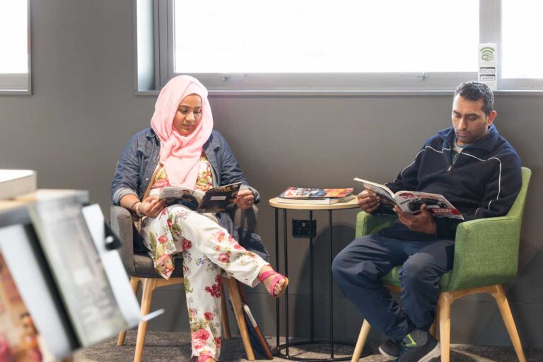 manawatu library couple relaxing and reading | Groundbreaking access: open+ in Manawatū Community Hub Libraries, New Zealand