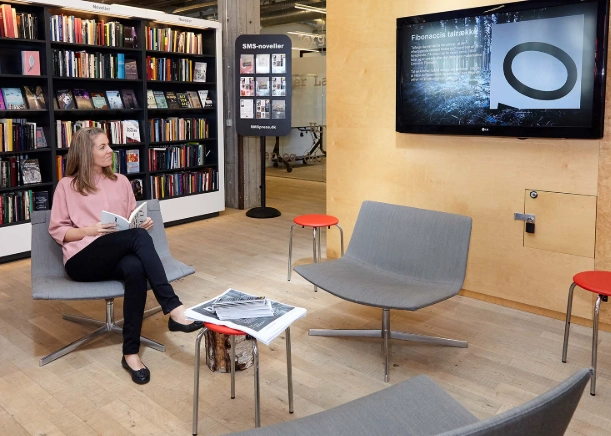 Library patron interacting with digital screen powered by uniFi+ from Bibliotheca