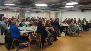 Library professionals attending the North Roadshow at The Stockroom, engaged in presentations and networking during the Bibliotheca event.