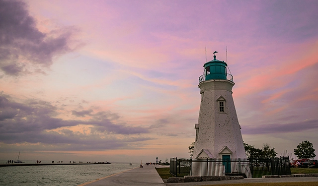 Port Dalhousie Lighthouse in St. Catharines at sunset with pink and purple sky
