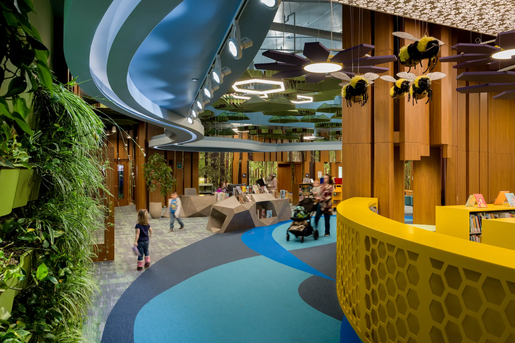 Children's area at Redford Township District Library with colorful design, plants, and bee decorations.