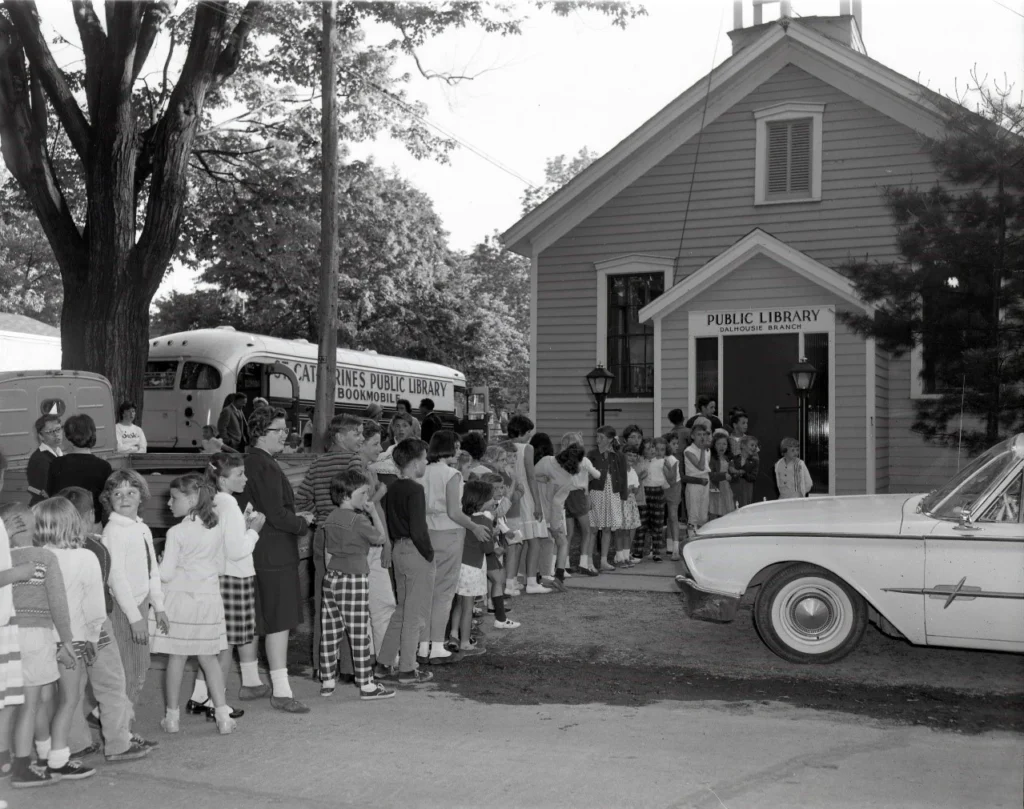 Crowd of children and adults outside Port Dalhousie Branch of St. Catharines Public Library during 1961 opening